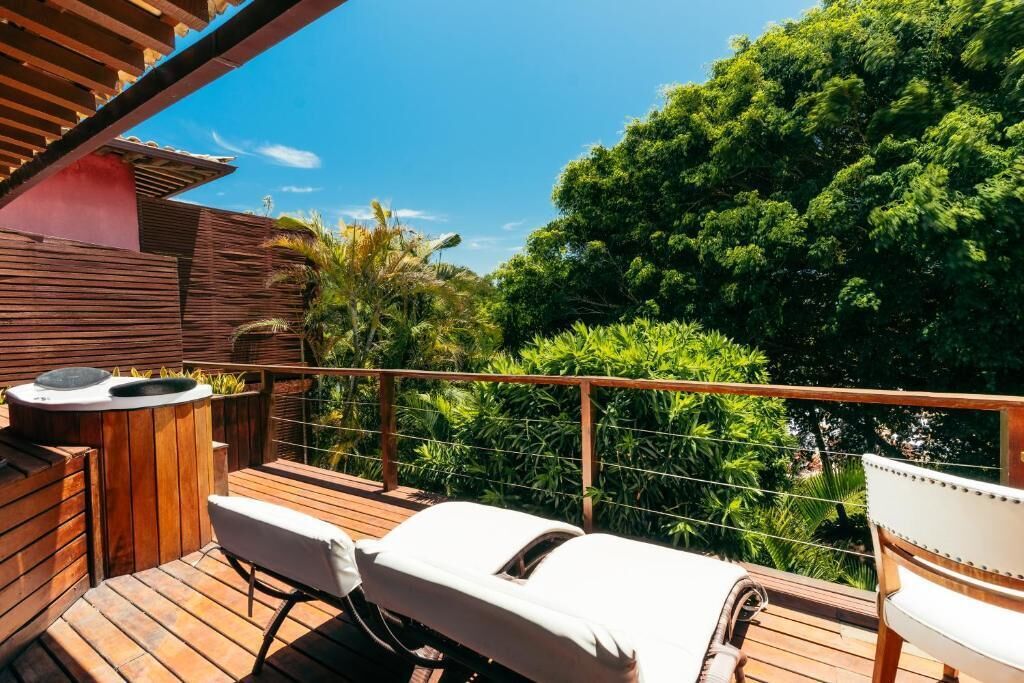 A wooden deck with two sun loungers and a small outdoor kitchen area.