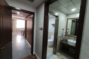 A hotel corridor with a wooden door leading to a bathroom with a sink and toilet. - Super 8 Hotel (Xingtai Railway Station Tianyi Square Kaixuan Branch) (Xingtai)