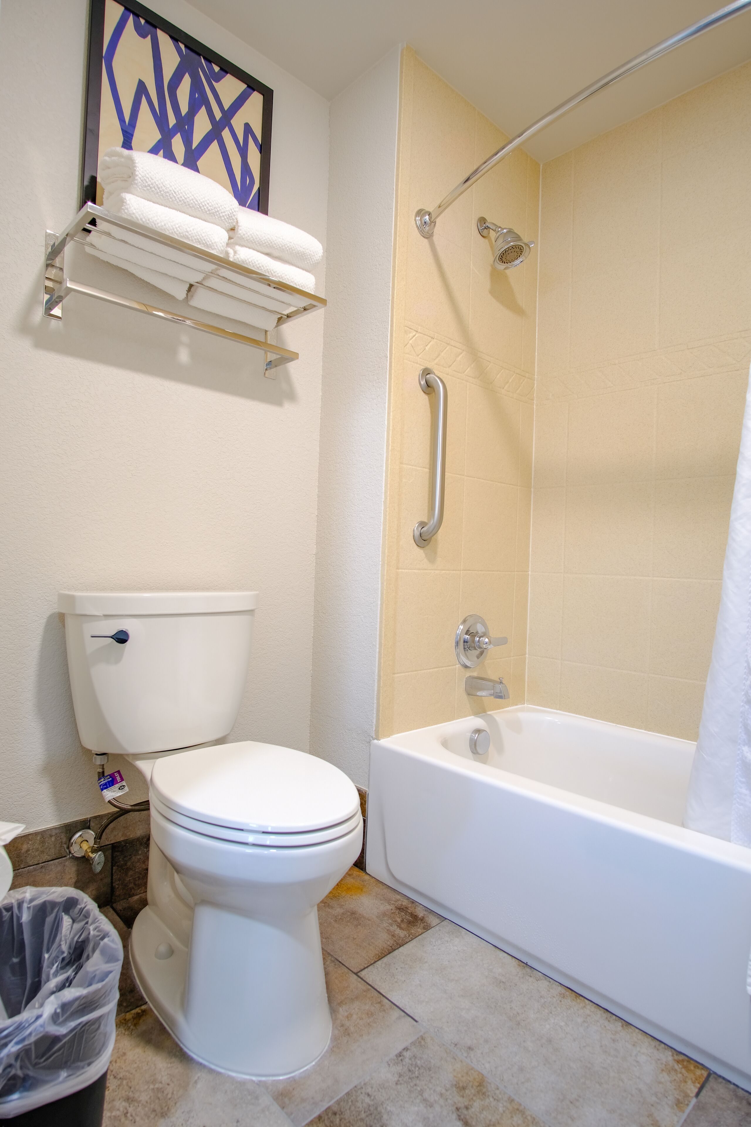 A bathroom with a toilet, a bathtub, and a shower.