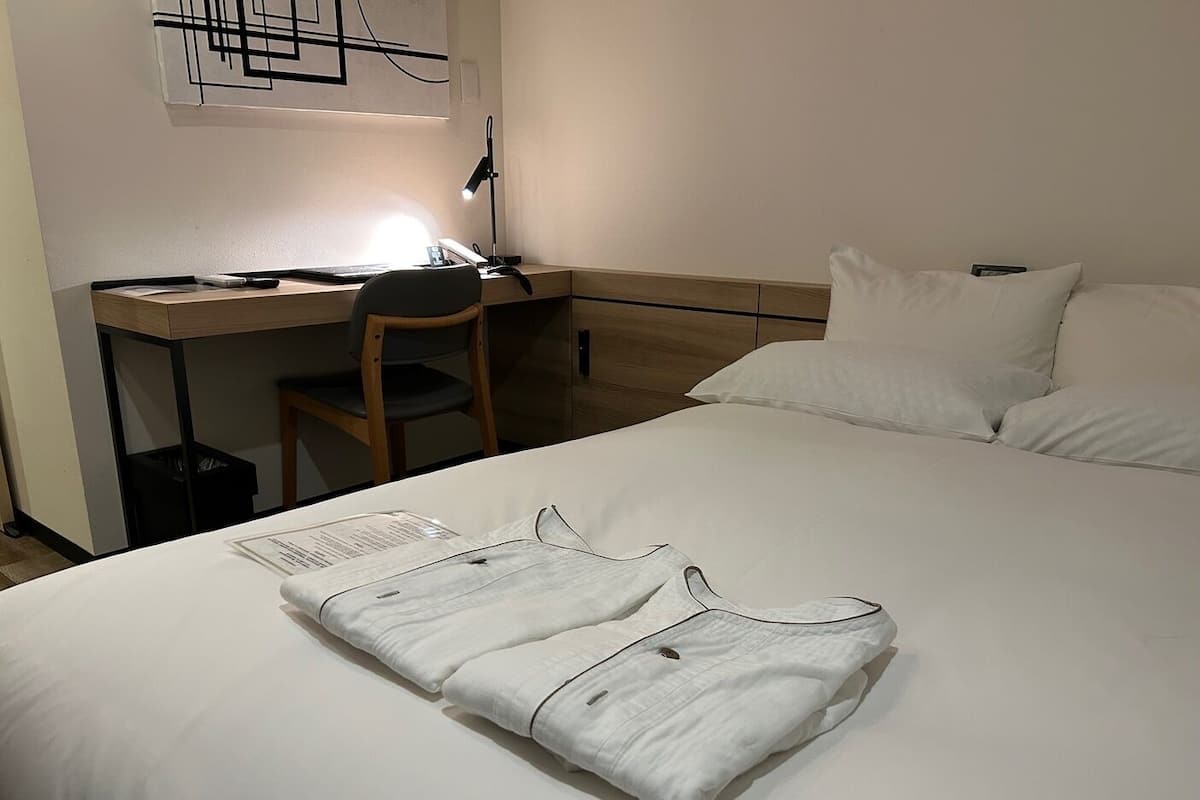 Literie de qualité, couette en duvet, bureau, rideaux d’obscurcissement