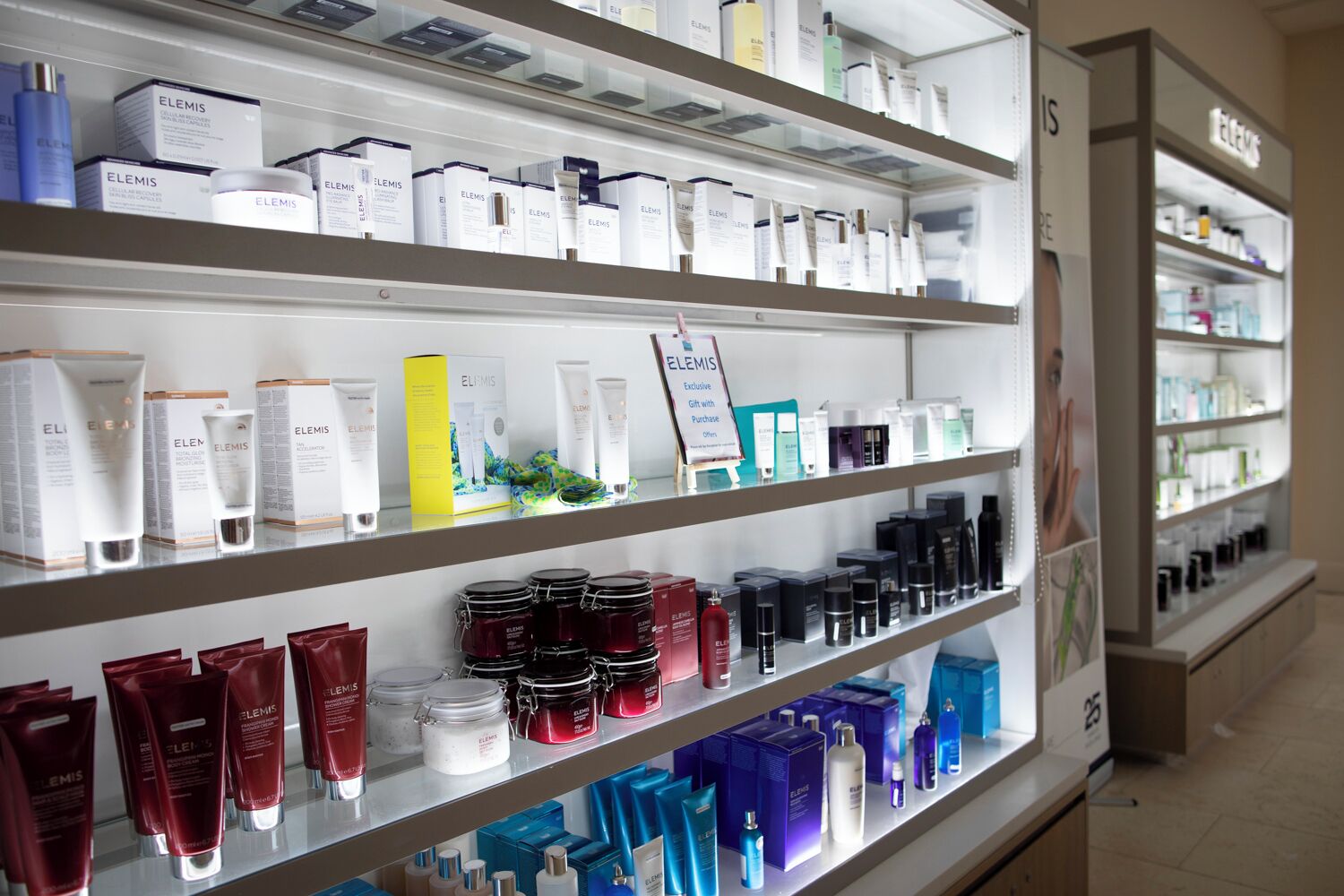 A pharmacy shelf stocked with various brands of skincare products.
