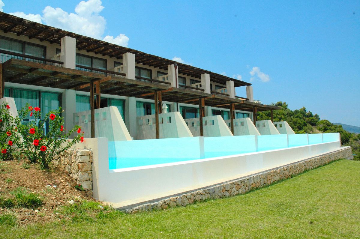 A modern building with a series of balconies and a pool area.