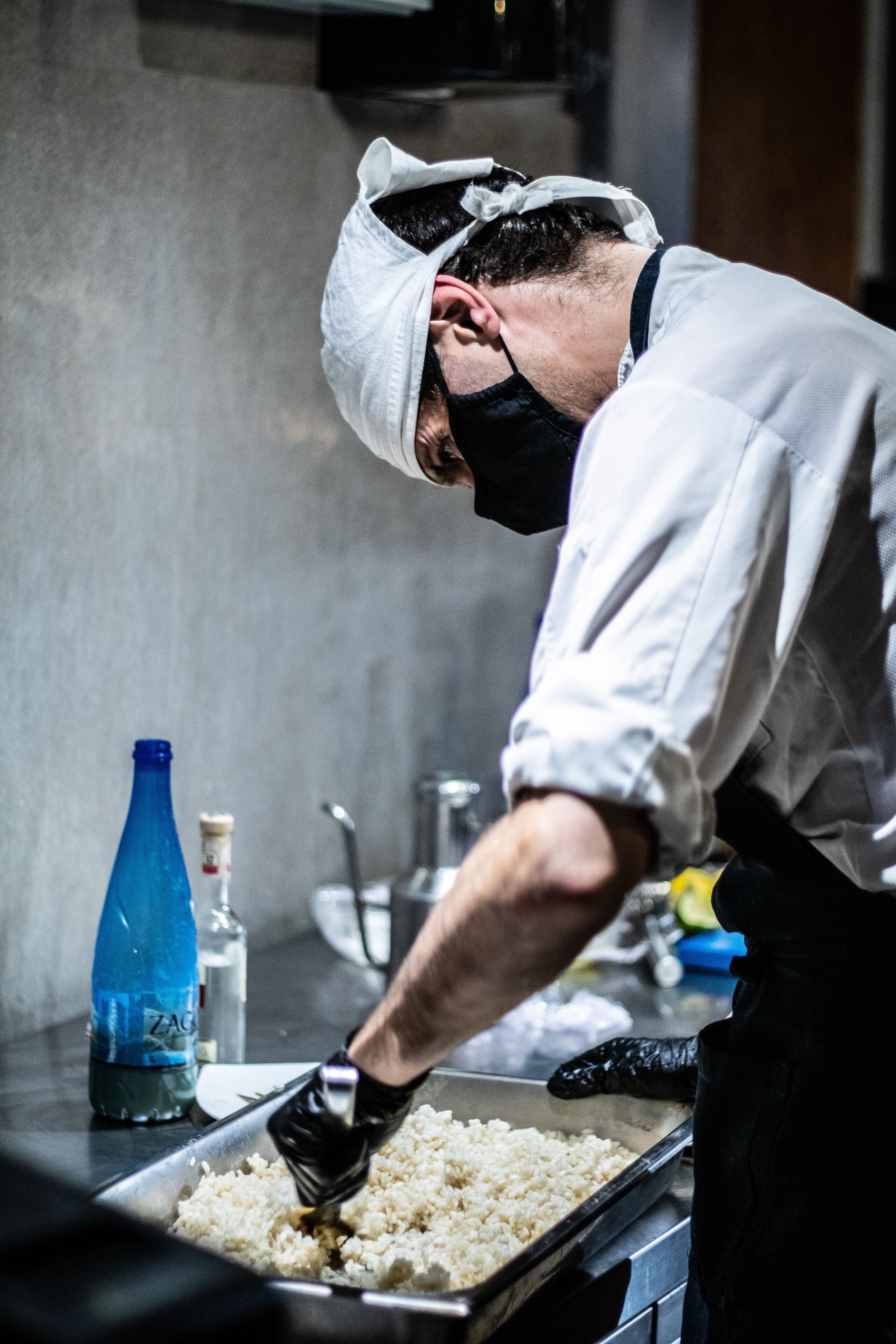 A person cooking rice in a kitchen.