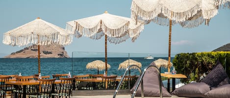 Seasonal outdoor pool, open 9:30 AM to 11:30 PM, pool umbrellas