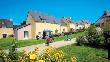 Residential complex with pitched roofs and well-manicured lawns.