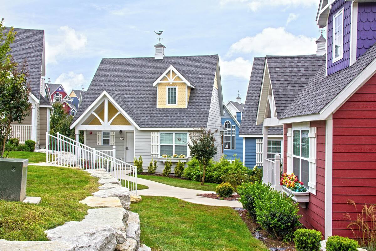 A residential neighborhood with houses featuring gabled roofs and front porches.