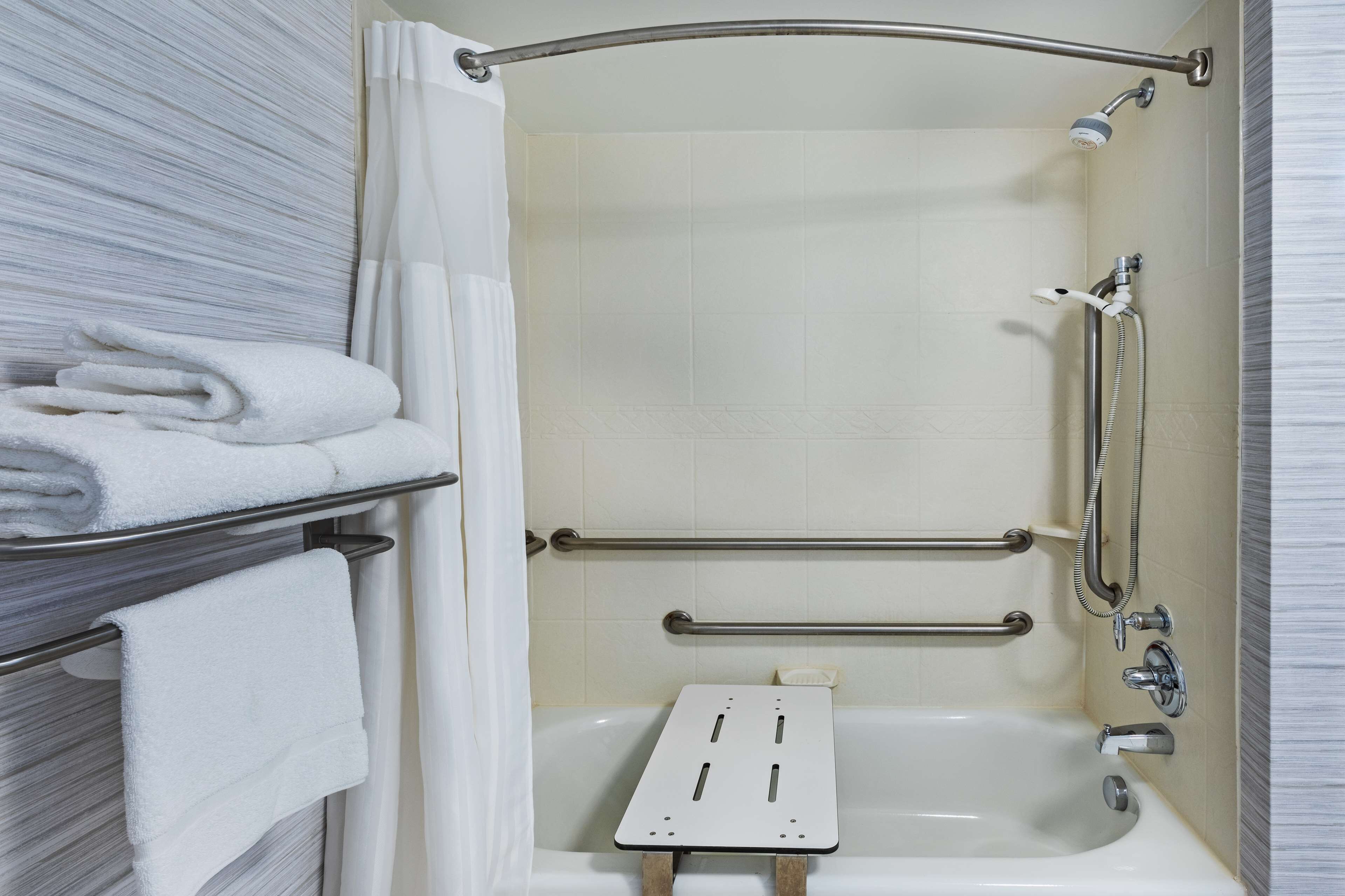 bathtub, designer toiletries, hair dryer, towels