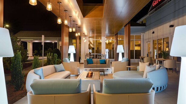 An outdoor seating area with modern furniture and pendant lighting at a Hilton Garden Inn. - Hilton Garden Inn Tifton (Tifton)