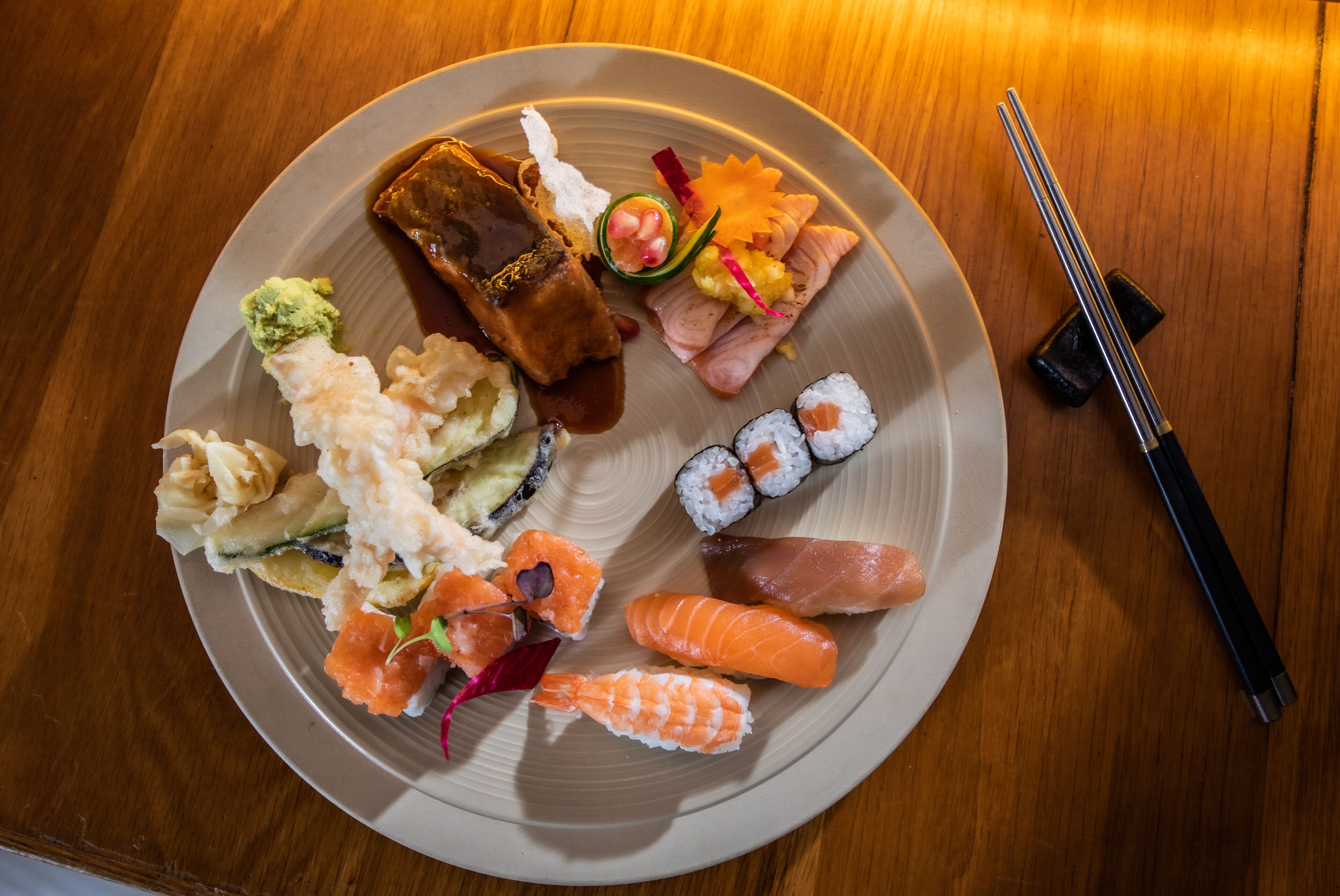 A plate of sushi with various types of fish and vegetables.
