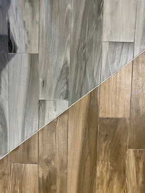 Primer plano de un piso de madera con diferentes tonalidades, desde claros hasta oscuros.