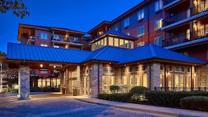 A multi-story hotel with a prominent entrance, stone pillars, and a covered area with a sign reading "Cliffhouse 1st".