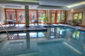 Relax by the pool surrounded by comfortable seating areas and lush views.