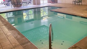 An indoor swimming pool with clear water, tiled floor, and a metal handrail. - Country Inn & Suites by Radisson, Knoxville at Cedar Bluff, TN (Knoxville)