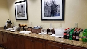 A hotel breakfast bar with coffee makers, a fruit display, and a variety of beverages. - Country Inn & Suites by Radisson, Knoxville at Cedar Bluff, TN (Knoxville)