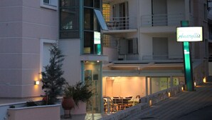 A hotel named Anargyllis with a modern design, featuring balconies and a well-lit entrance. - Amaryllis Hotel Apartments (Nafplio)