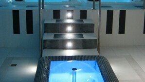 Un espace spa comprenant plusieurs bains à remous et une fontaine centrale.