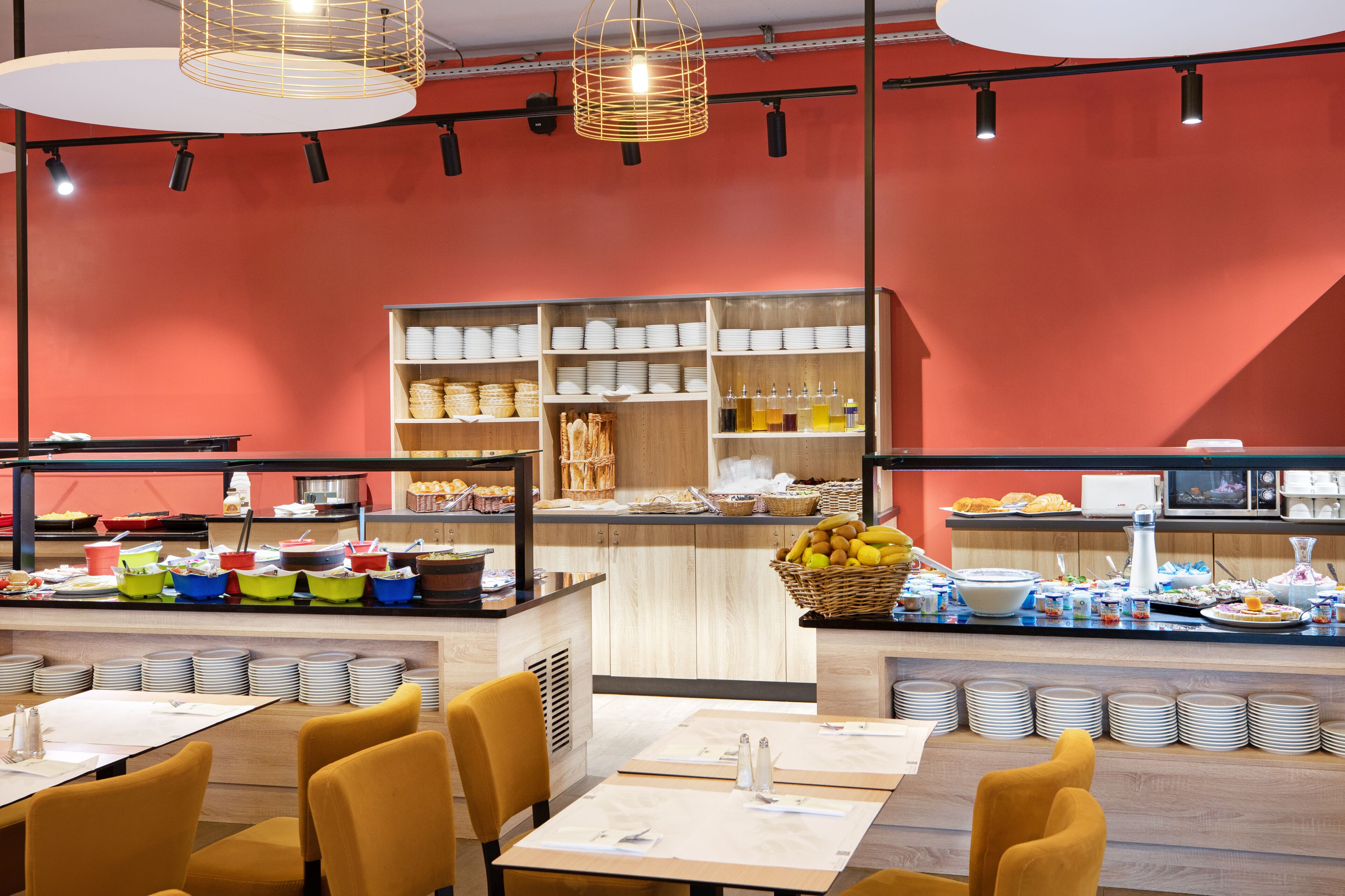 A buffet area with multiple serving stations, a variety of food items, and seating arrangements.