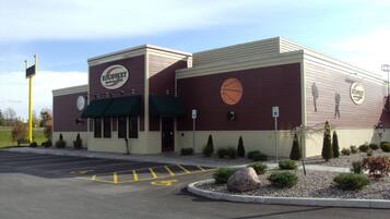 A building with a sign reading "Recovery Sports Bar & Grill" and a basketball graphic on the wall.