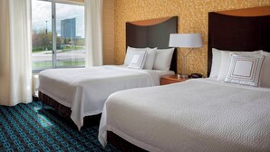 A hotel room with two beds, a large window, and a patterned carpet. - Fairfield by Marriott Inn & Suites Verona Turning Stone (Verona)