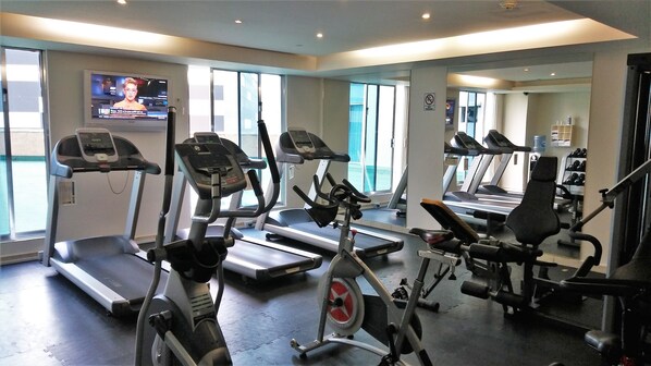 A gym with treadmills, elliptical machines, and weight equipment. - BelAir Business a Wyndham Garden Hotel (Mexico City)