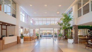 A spacious lobby with a reception desk, seating areas, and large windows allowing natural light. - Beach Park Wellness Resort (Aquiraz)