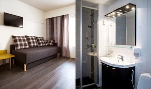 Ein modernes Schlafzimmer mit Bett, Fernseher und Nachttisch. Das Badezimmer verfügt über eine Glasdusche, ein Waschbecken und einen Spiegel.