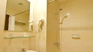 A bathroom with a sink, mirror, towel rack, and a shower with a handheld showerhead.