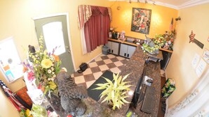 A kitchen with a checkered floor, a sink, a stove, and a refrigerator. - Palace Inn Oxnard (Oxnard)