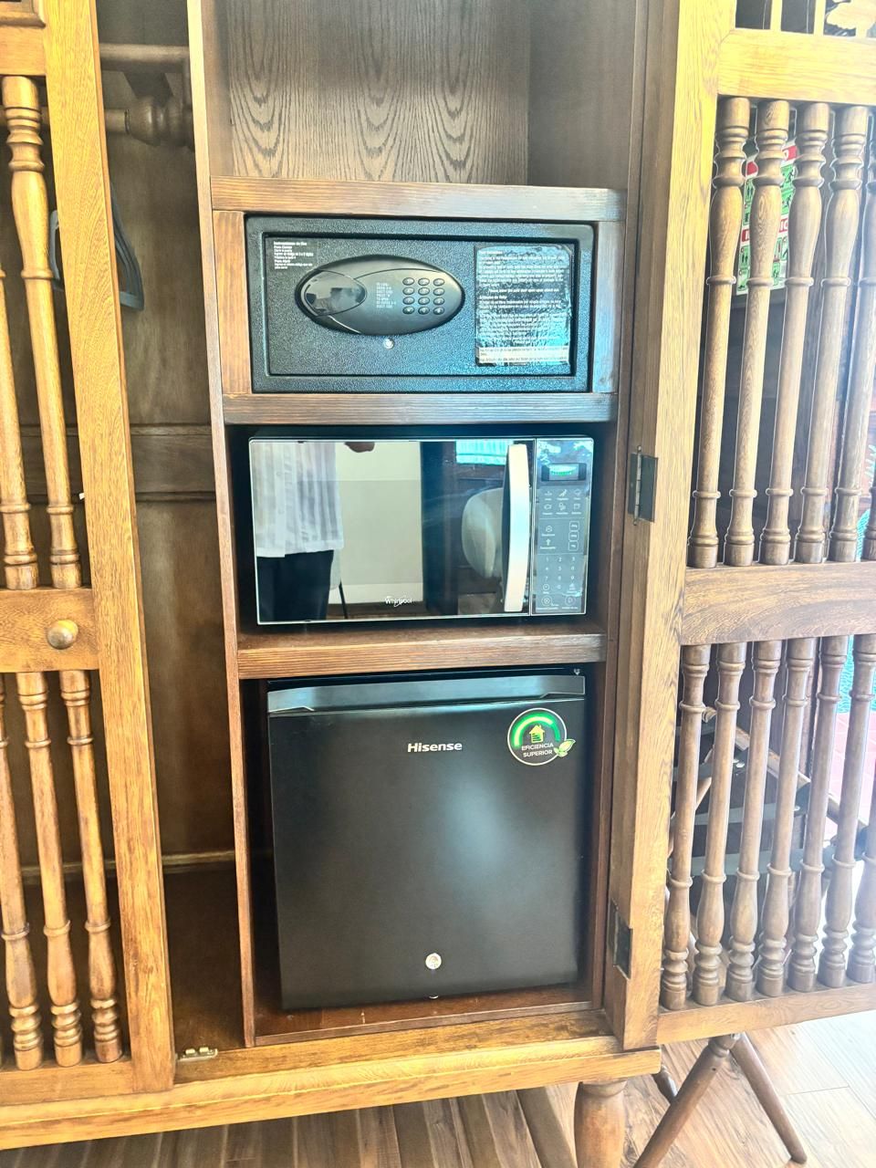 A compact kitchen with a microwave and a refrigerator.