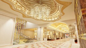 A grand hotel lobby with a marble floor, ornate chandeliers, and a central staircase. - NagaWorld Hotel & Entertainment Complex (Phnom Penh)