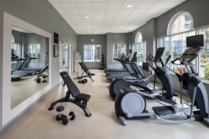 A gym with treadmills, elliptical machines, and weight benches. - Homewood Suites by Hilton Lake Buena Vista - Orlando (Orlando)