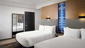 A hotel room with two beds, a mirror, a wardrobe, and a digital display on the wall. - Aloft by Marriott Arundel Mills BWI Airport (Hanover)