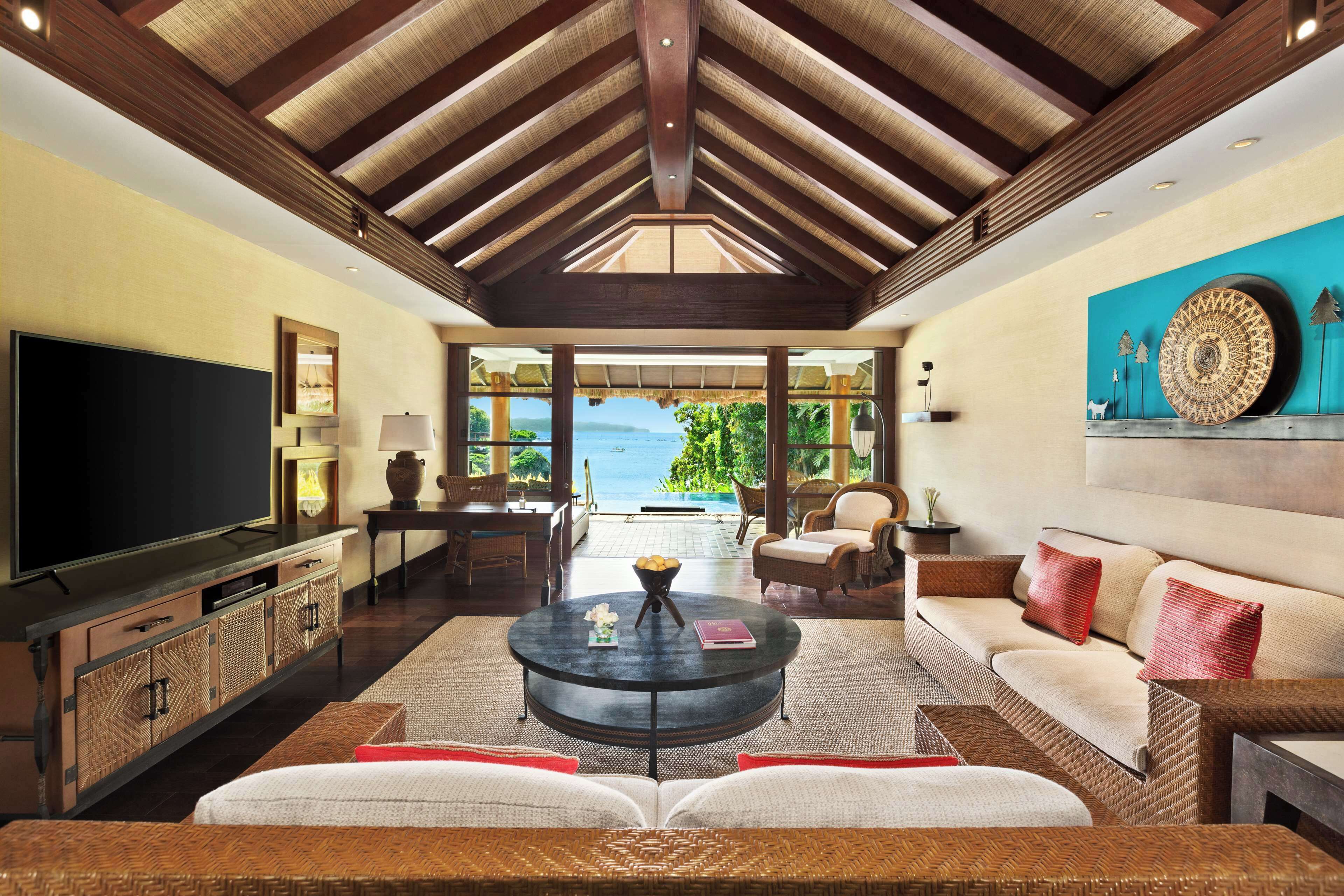 2 bedroom ocean villa | living area | flat-screen tv, dvd player, ping pong, books