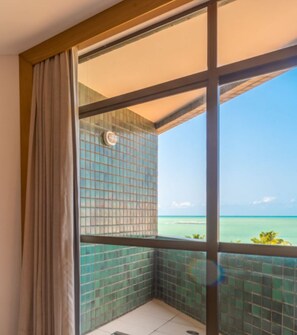 A balcony with a view of the ocean.