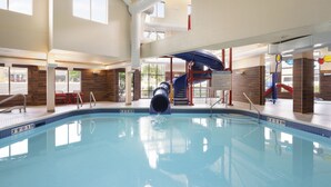 An indoor swimming pool with a slide, a play area, and a view of the outside. - Fairfield Inn & Suites by Marriott West Kelowna (West Kelowna)