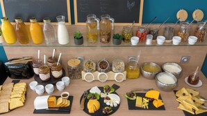 A buffet with various food items and beverages.