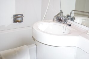 A white bathroom with a sink, a mirror, and a towel rack. - Smile Hotel Kumagaya (Kumagaya)