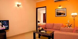 Luxury Suite | Living room | 29-inch flat-screen TV with satellite channels, TV, DVD player - Shilton Royale (Bengaluru)