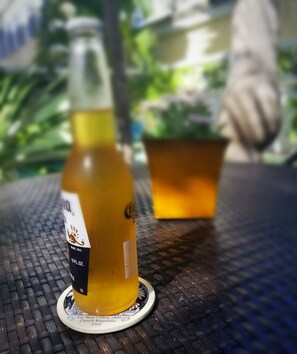 A bottle of Marc's Reserve 12 FL. OZ. on a coaster with a metal table.