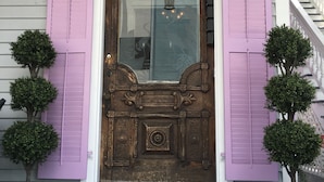A front door with purple shutters, a small porch, and a doormat with 'The Artist House Circa 1890' text. - Artist House Key West (Key West)