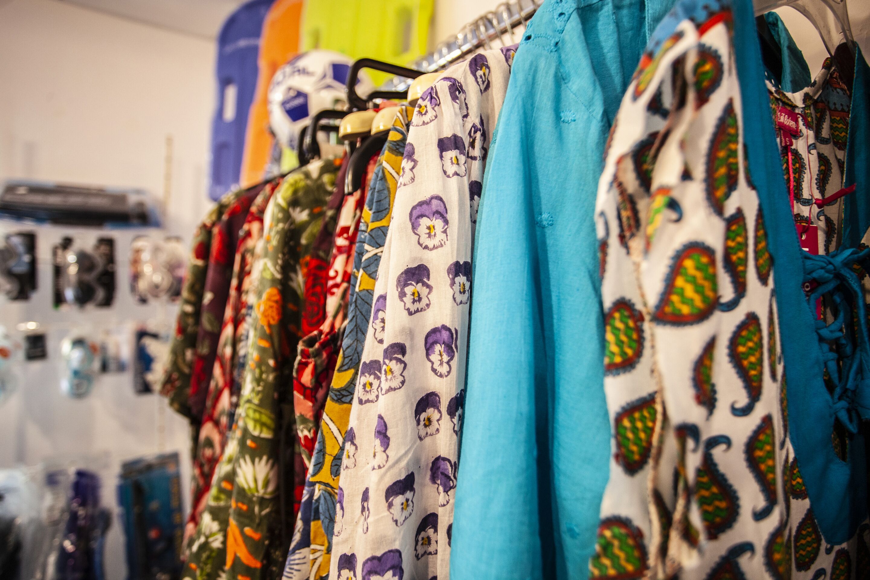 A clothing store with various garments on display.