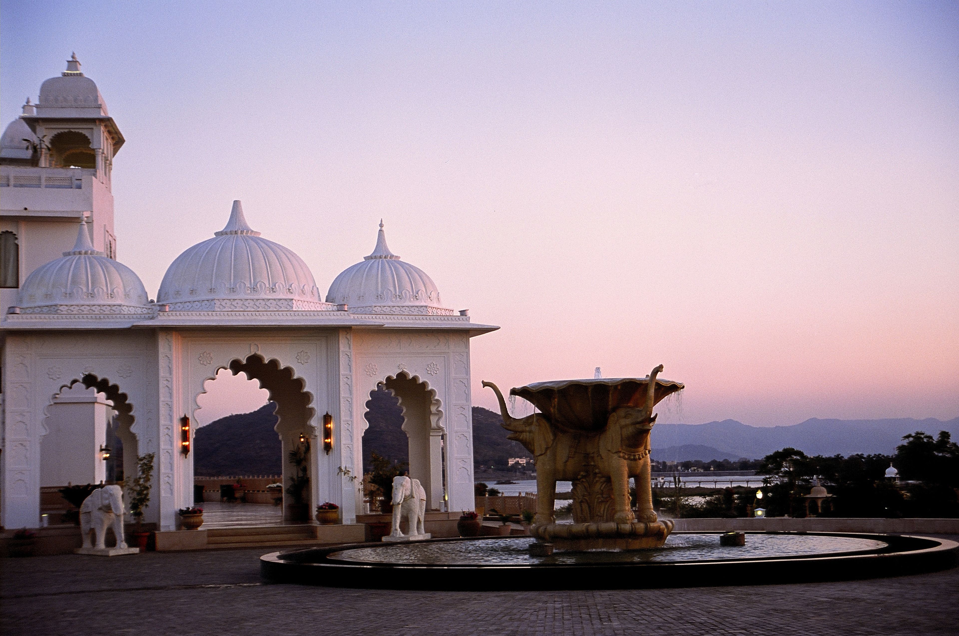 A building with domed architecture and a fountain.
