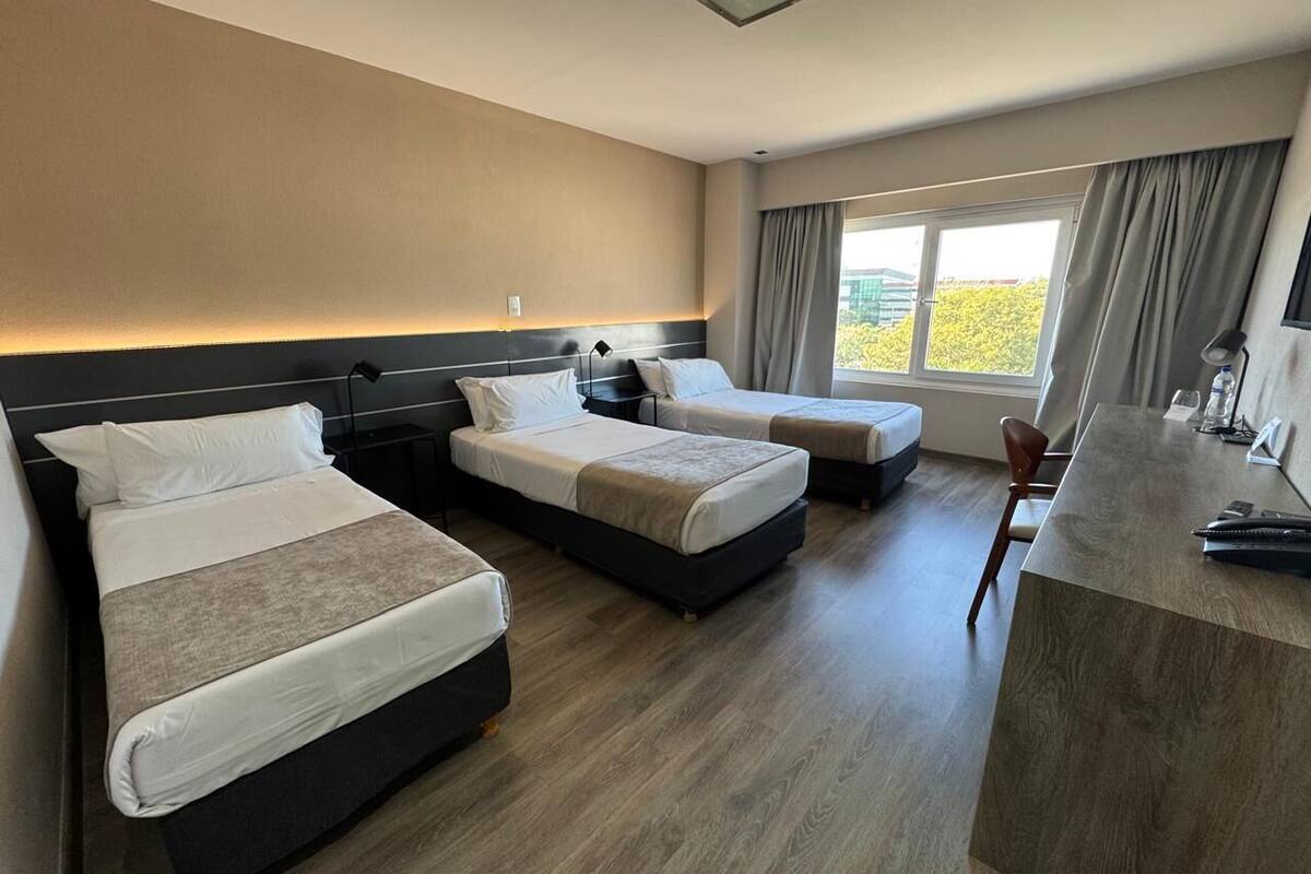 Triple Room | Minibar, in-room safe, desk, blackout curtains