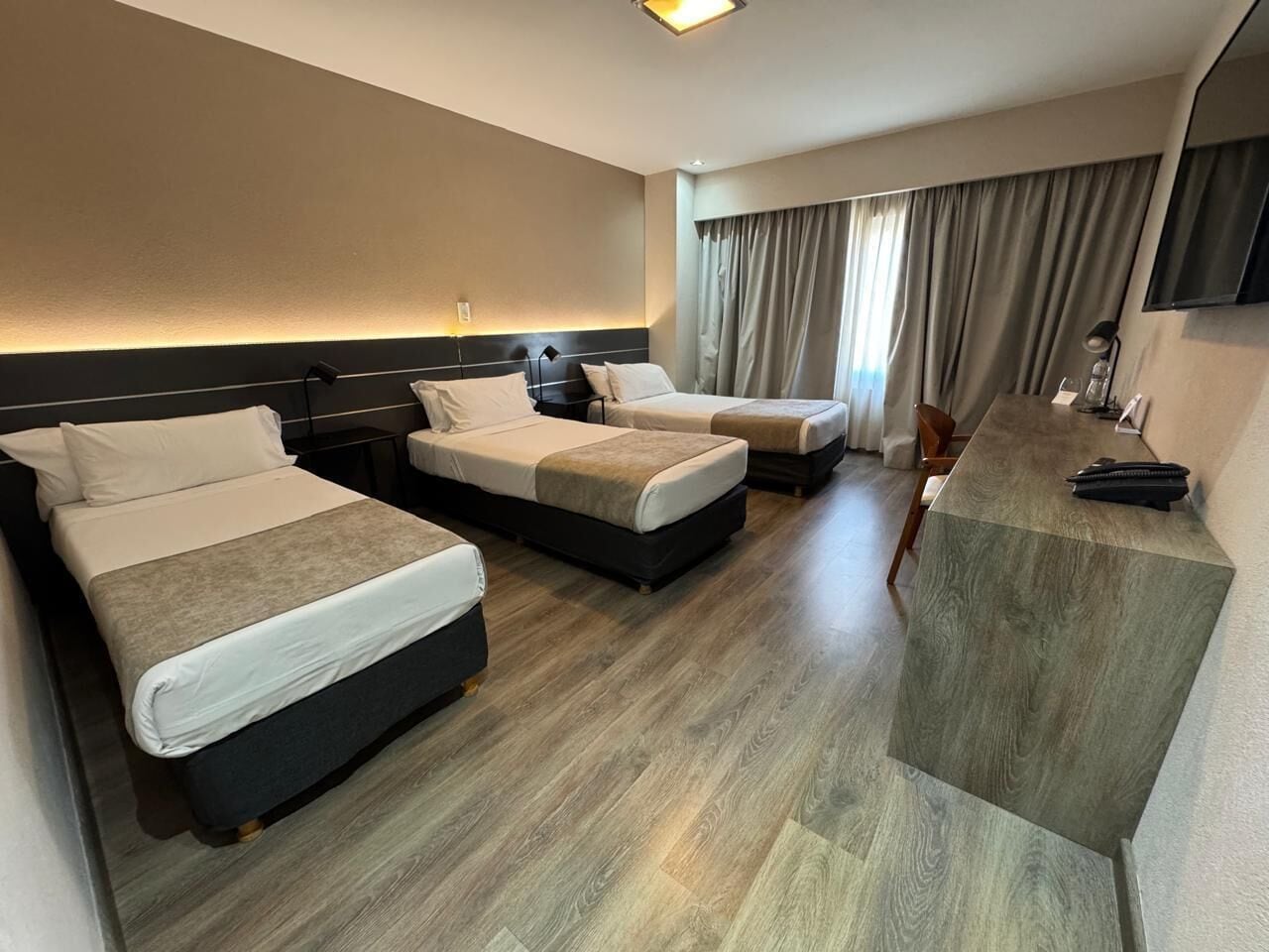 Triple Room | Minibar, in-room safe, desk, blackout curtains