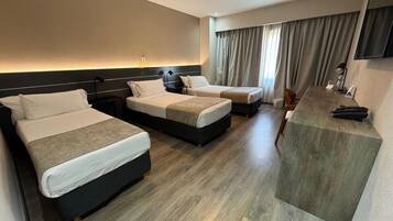 Triple Room | Minibar, in-room safe, desk, blackout curtains