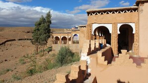 A traditional building with arched doorways and a courtyard.