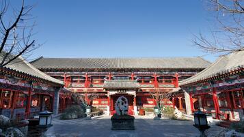 A traditional building with a symmetrical facade, multiple levels, and red and white color scheme.