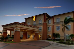 A hotel with a covered entrance, multiple floors, and a sign indicating it is a Marriott hotel. - Super 8 by Wyndham Hidalgo/McAllen Area (Hidalgo)