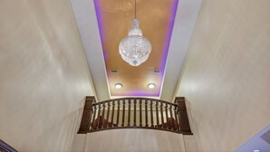 A chandelier hanging from a ceiling with recessed lighting. - Super 8 by Wyndham Hidalgo/McAllen Area (Hidalgo)