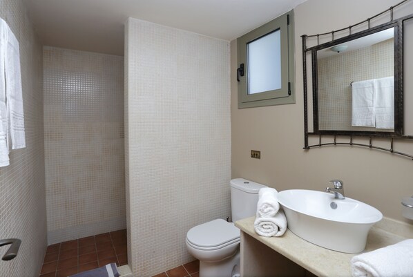 A bathroom with a toilet, sink, and shower area. - Achlada - Mourtzanakis Residence (Malevizi)